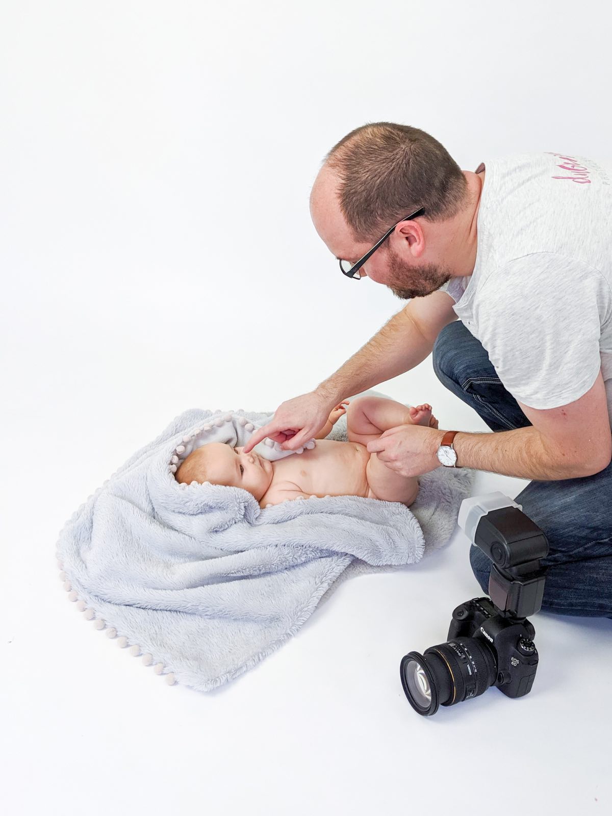 Behind the scenes of photographer posing 6 month old baby