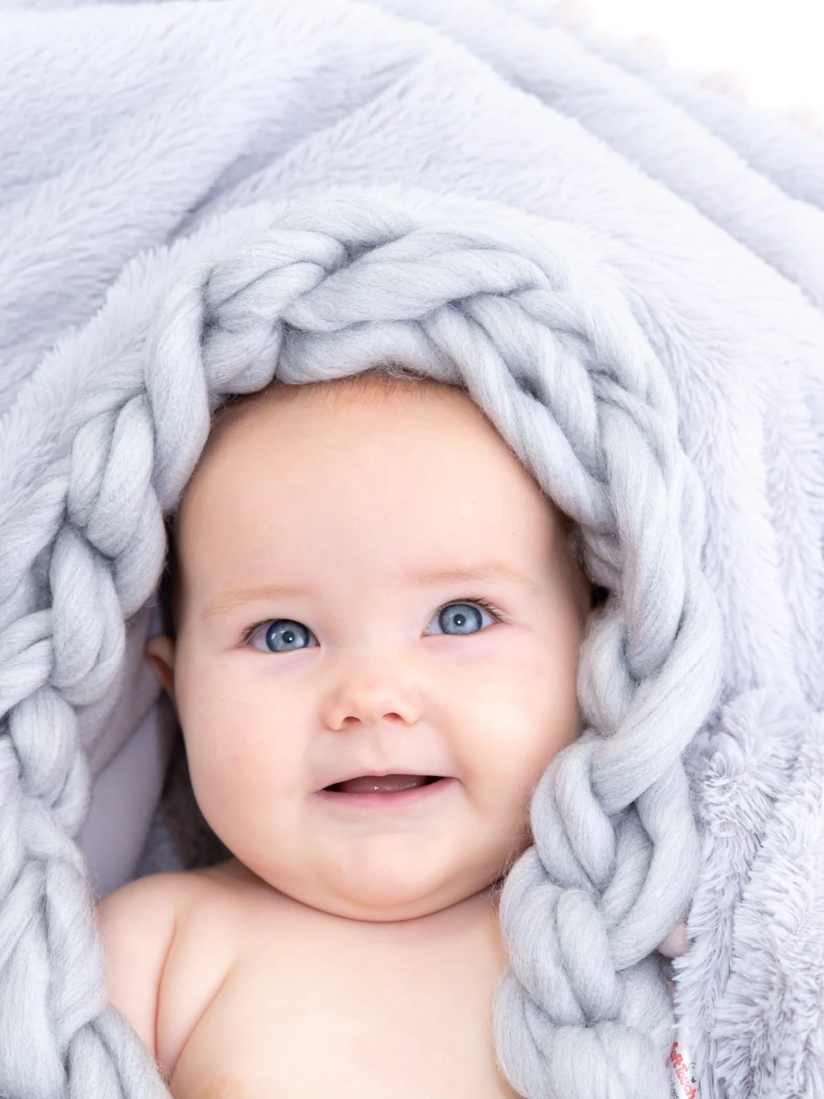 6 month old smiling and giigling at the camera