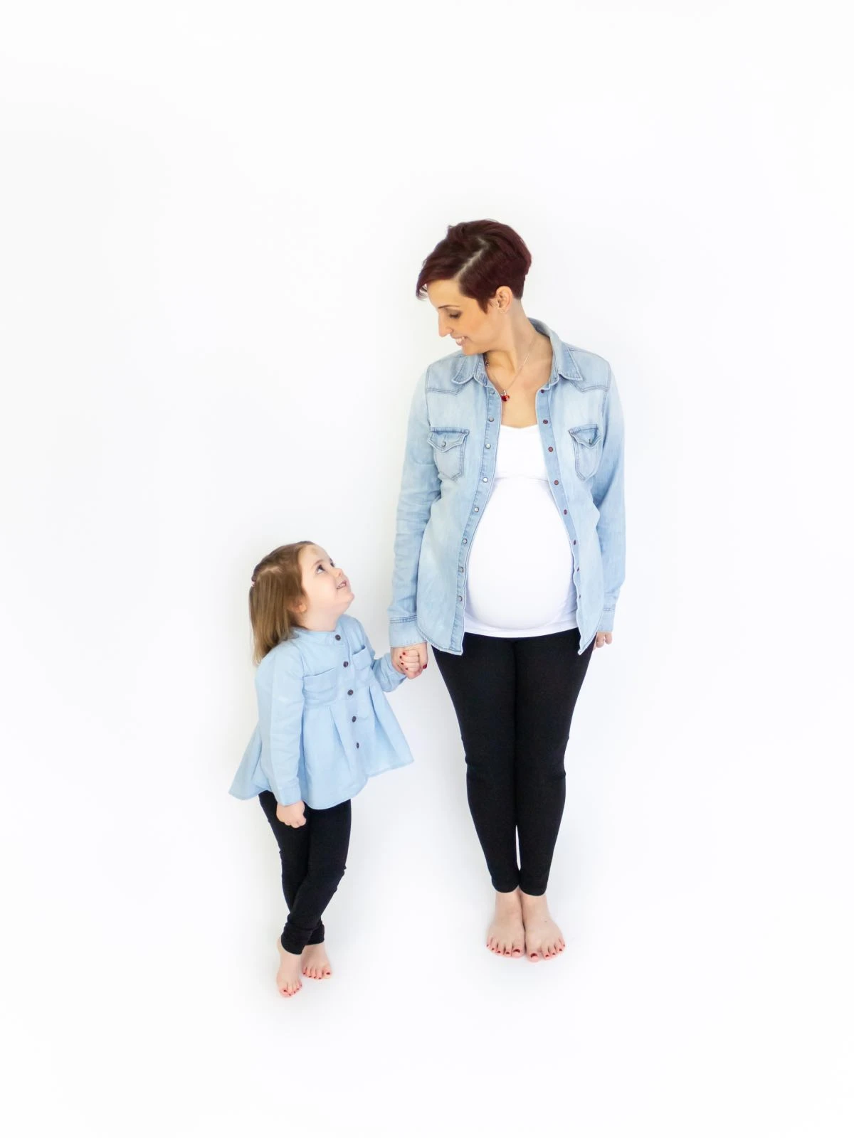 Mother and daughter holding hands