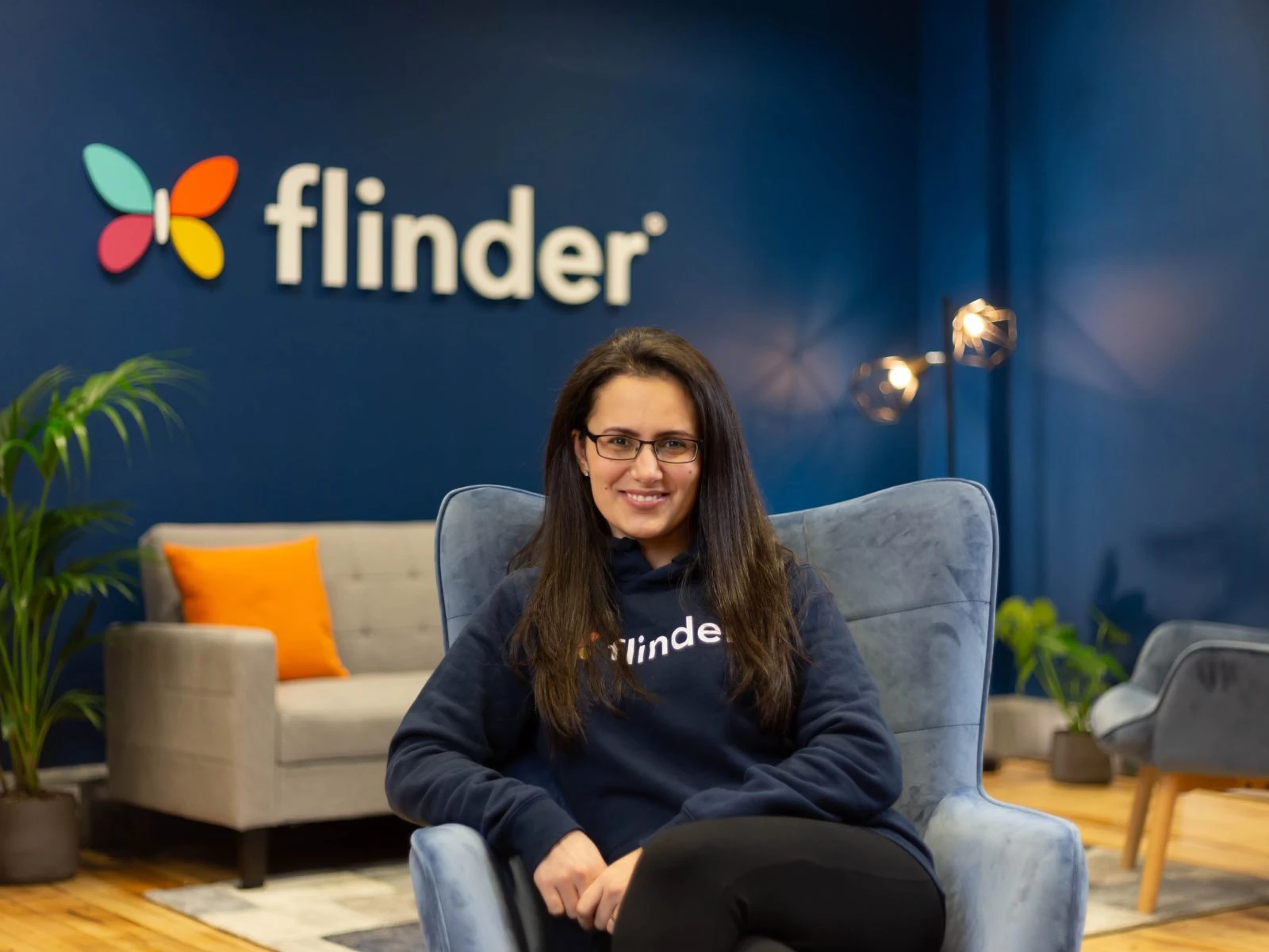 Branded photoshoot, power pose woman sitting in chair