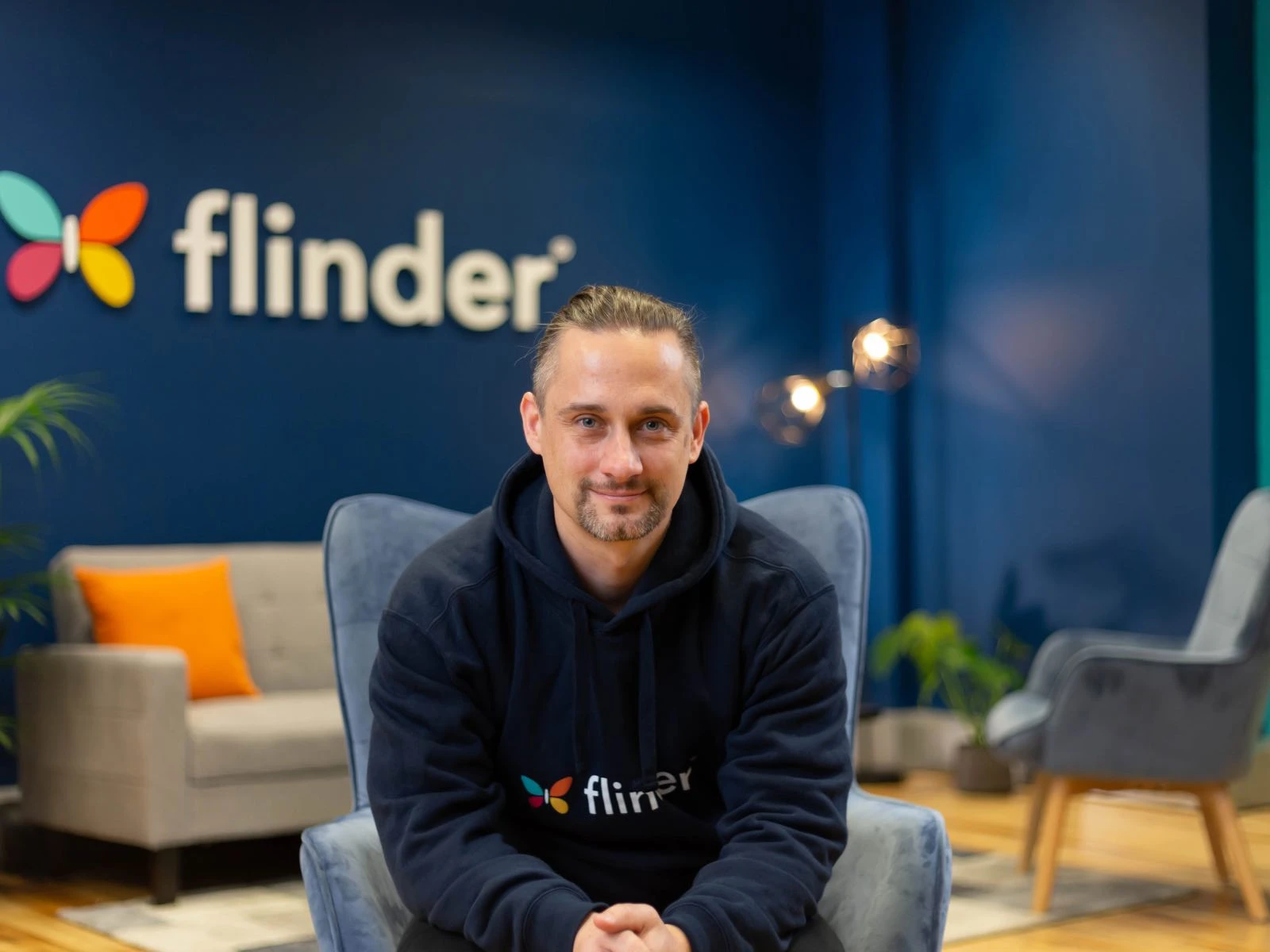 Branded photoshoot, man sitting in chair