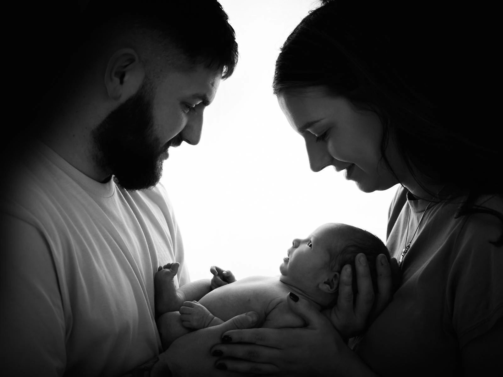 Stylistic photo of mum and dad with newborn baby